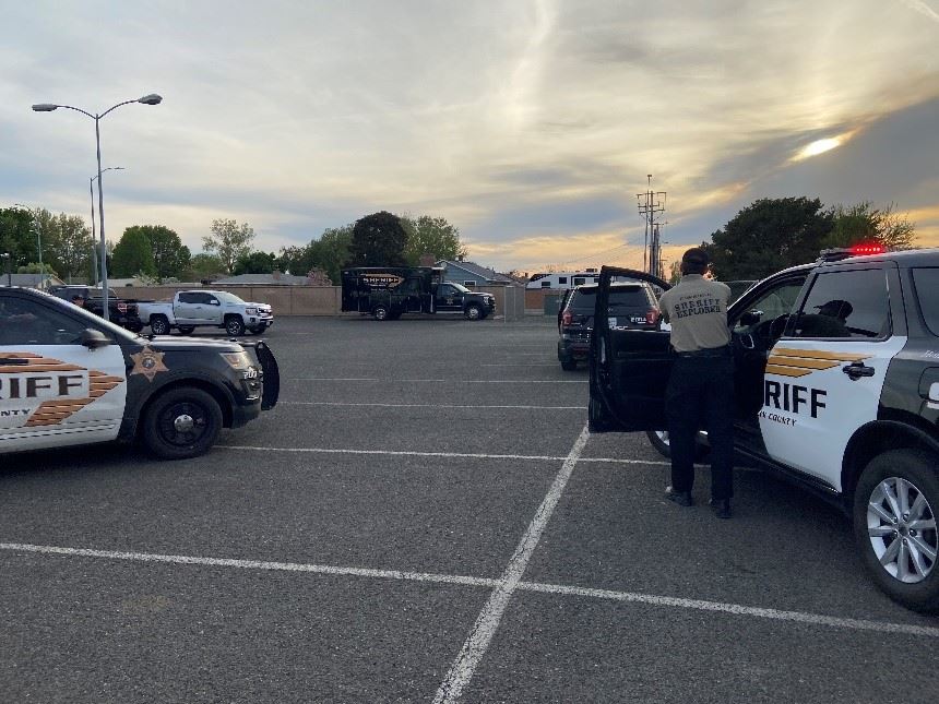 An explorer participates in a high-risk traffic stop mock scene.